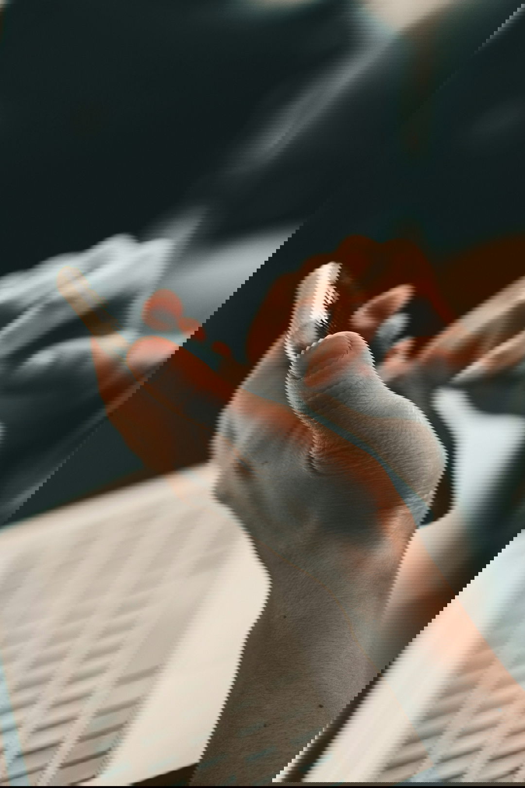 person holding black and white pen